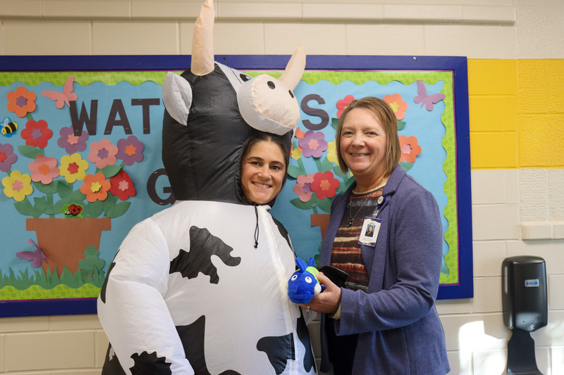 Tammy Gardner wearing a cow Halloween costume with Dr. Guffin