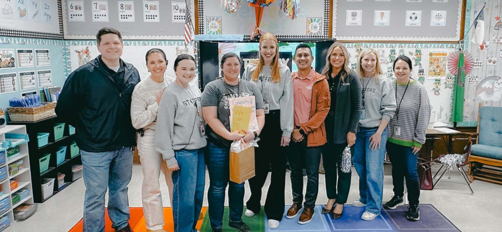 A group photo of an award winner during the prize patrol