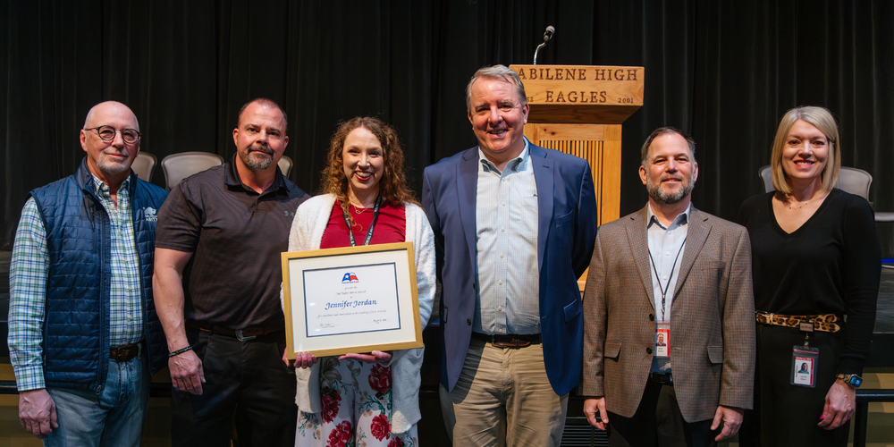 A photo of Jennifer Jordan and others at the award ceremony