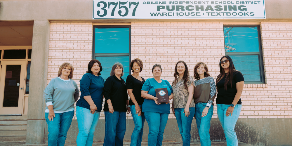 Purchasing Team Holding Purchasing Award Outside of Building