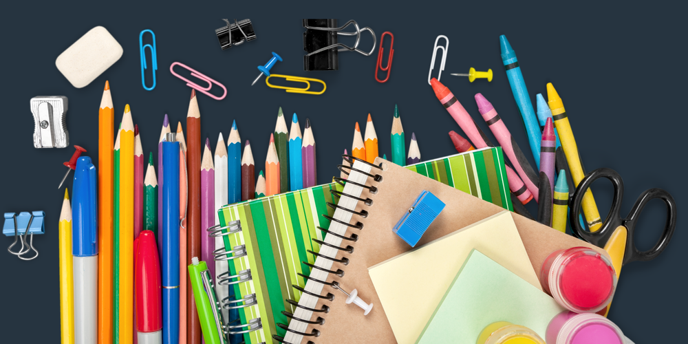 A compilation of school supplies against a dark blue background