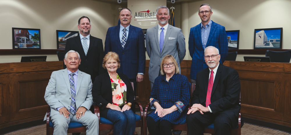 A photo of the board of trustees with the superintendent