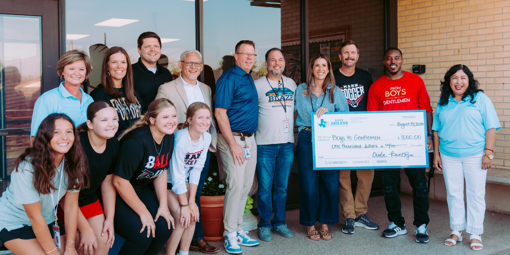 Group photo in front of Mann with KAB donation check