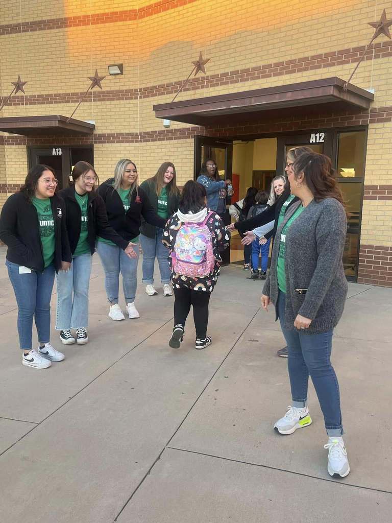 Students arriving at school during High Five Friday
