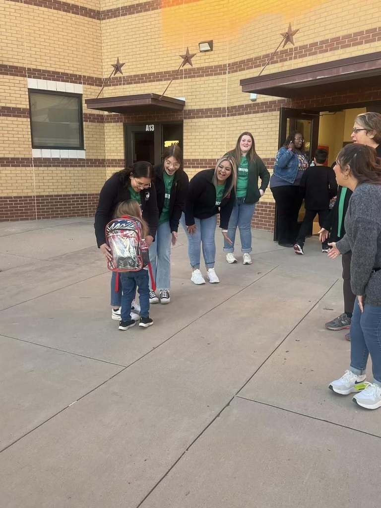 Students arriving at school during High Five Friday