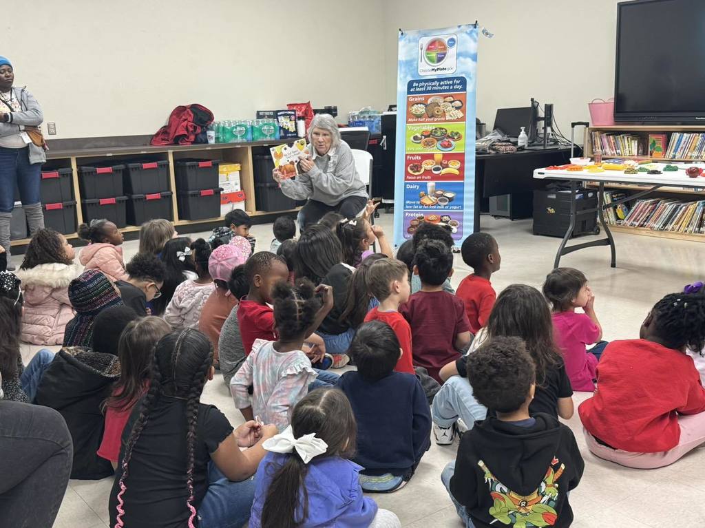 Children listen to a lesson on healthy foods
