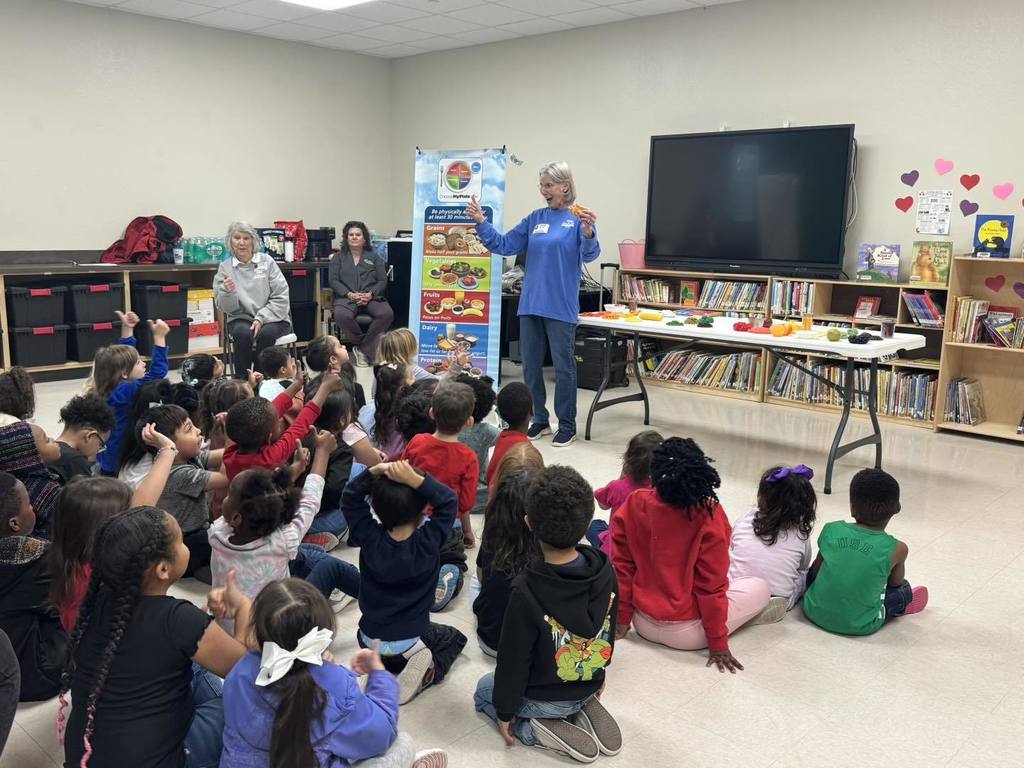 Children listen to a lesson on healthy foods