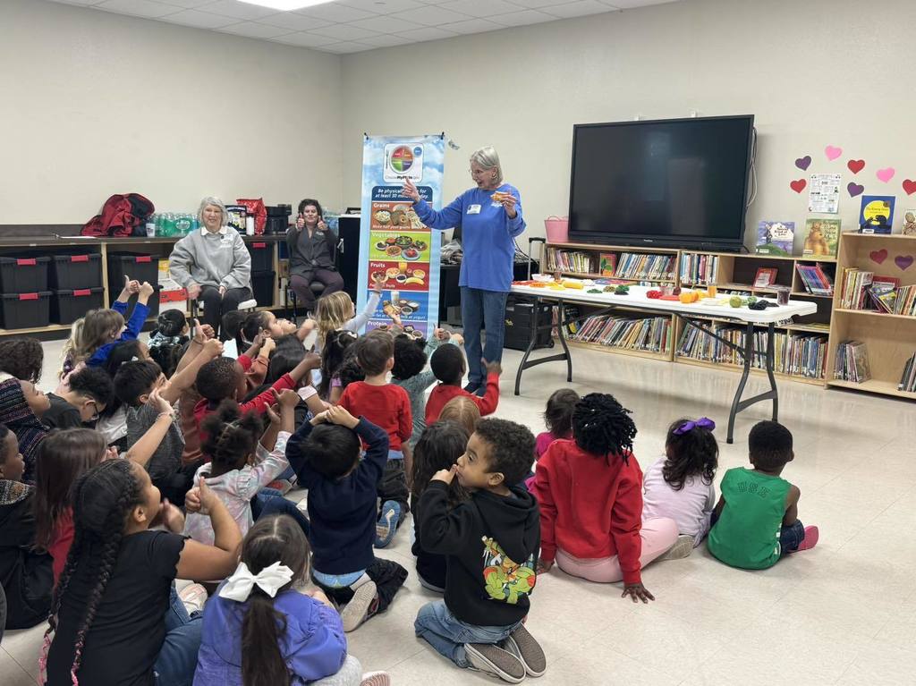 Children listen to a lesson on healthy foods