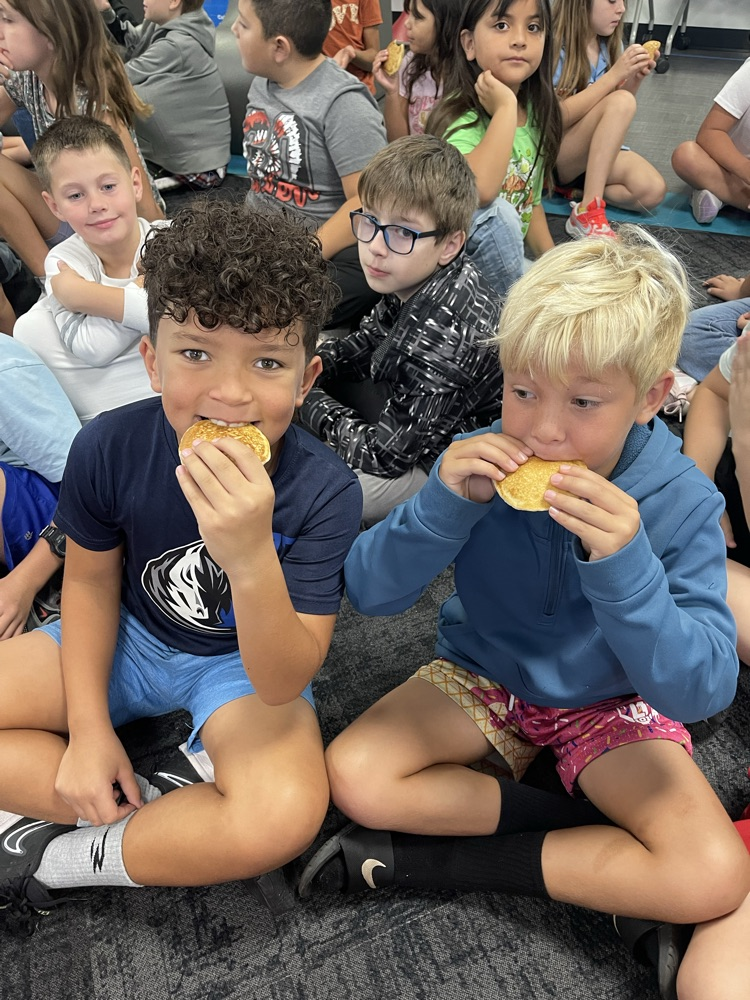 two students eating pancakes 