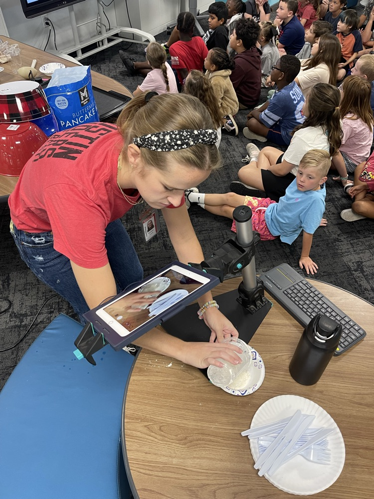 teacher mixing pancake mix for experiment 