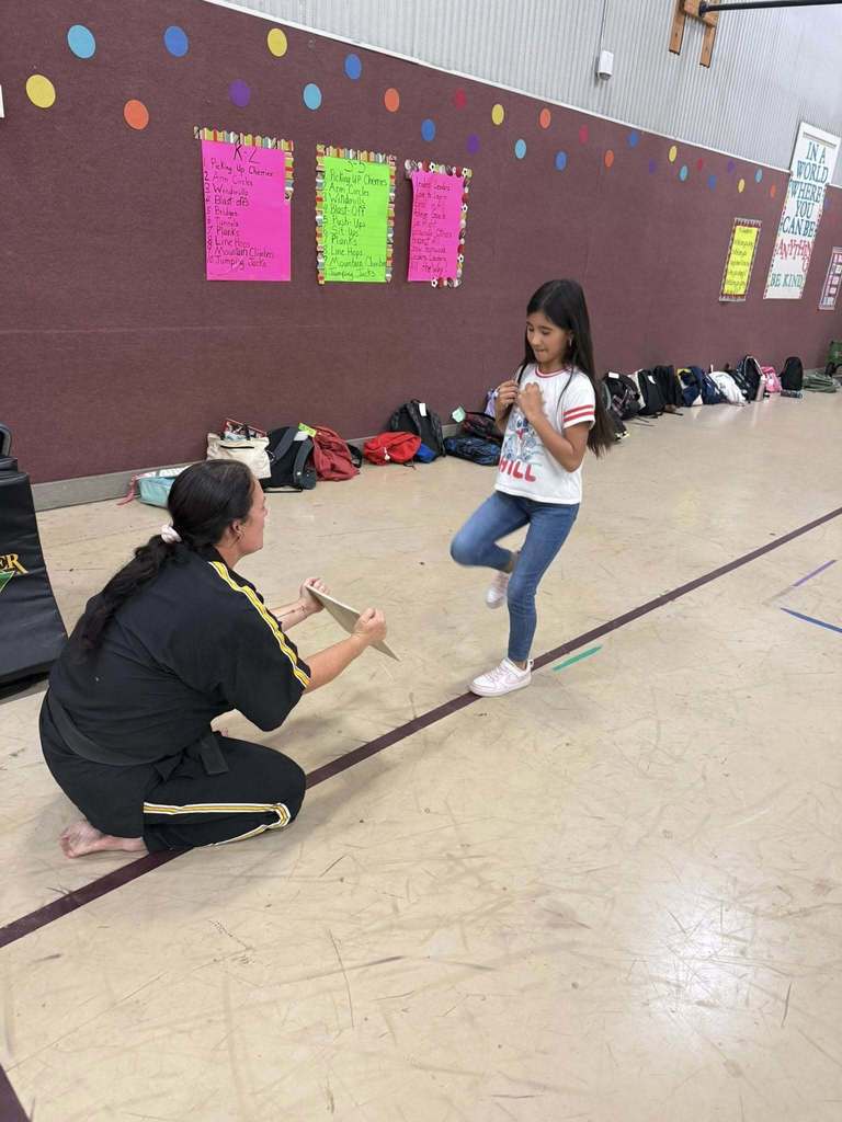 Students participate in a karate presentation