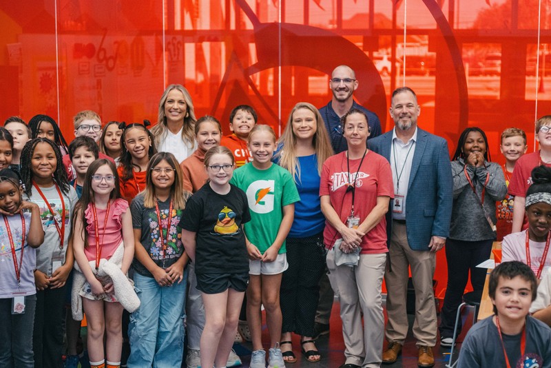 A photo of Melissa Pine, campus and district administrators, and Taylor students