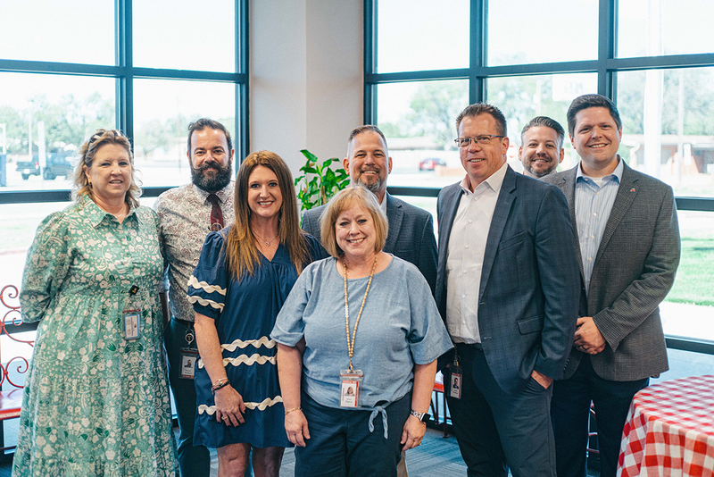 A photo of Susan Blagrave, campus, and district administrators