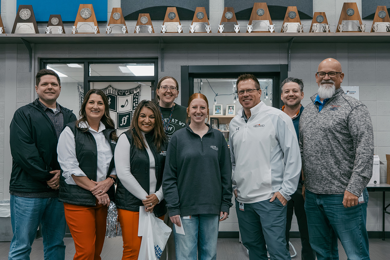 A photo of Mrs. Queen and members of the prize patrol