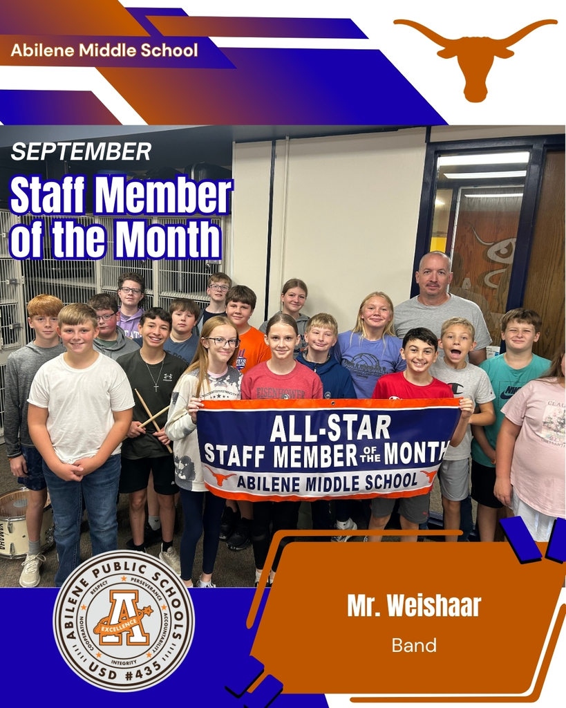AMS Staff member of the Month - Toby Weishaar and a group of his band students pose with a sign