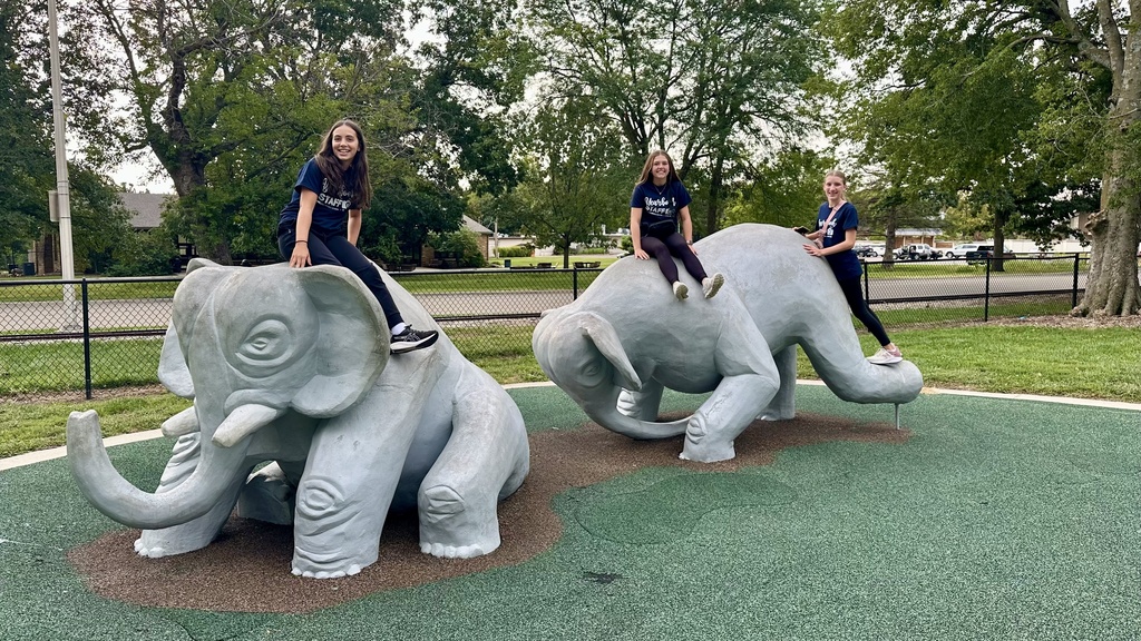 AMS Yearbook Staff sitting on cement elephant statues at the Topeka Zoo