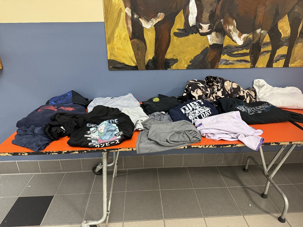 Lost and Found table with lots of sweatshirts