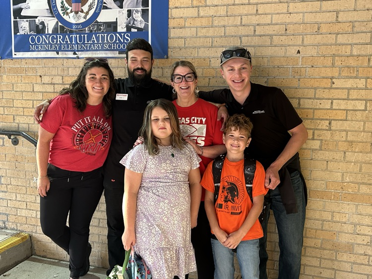 Students with Wests Country Mart employees