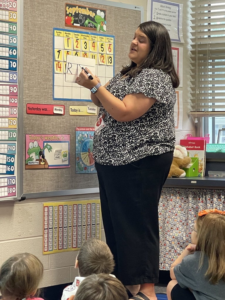 Mrs. Demars modeling how to make capital and lowercase R.