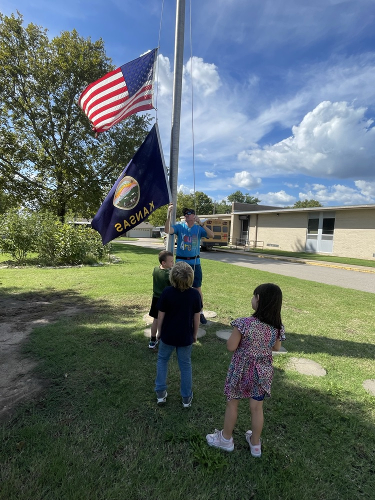 students helping take down the flag.