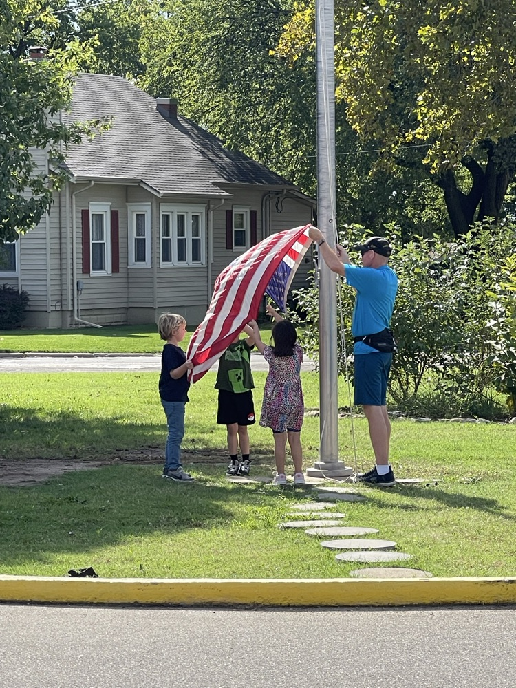 American flag coming down.