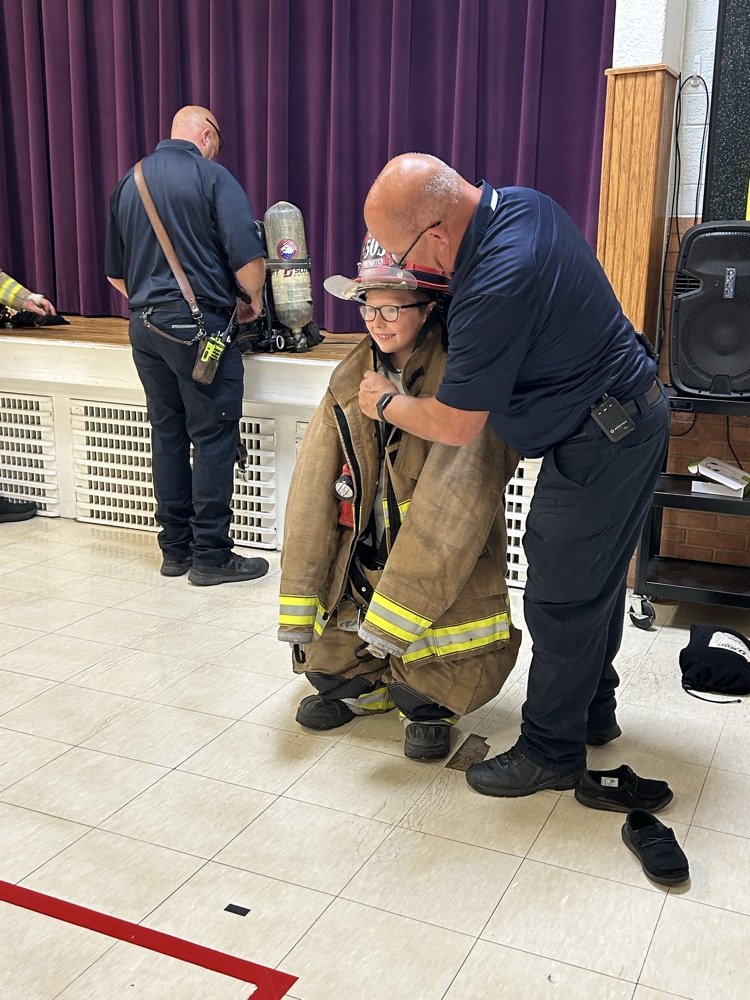 student getting in the fireman gear!