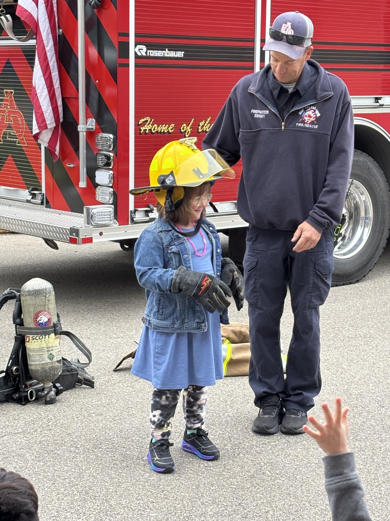 Student trying on helmet.