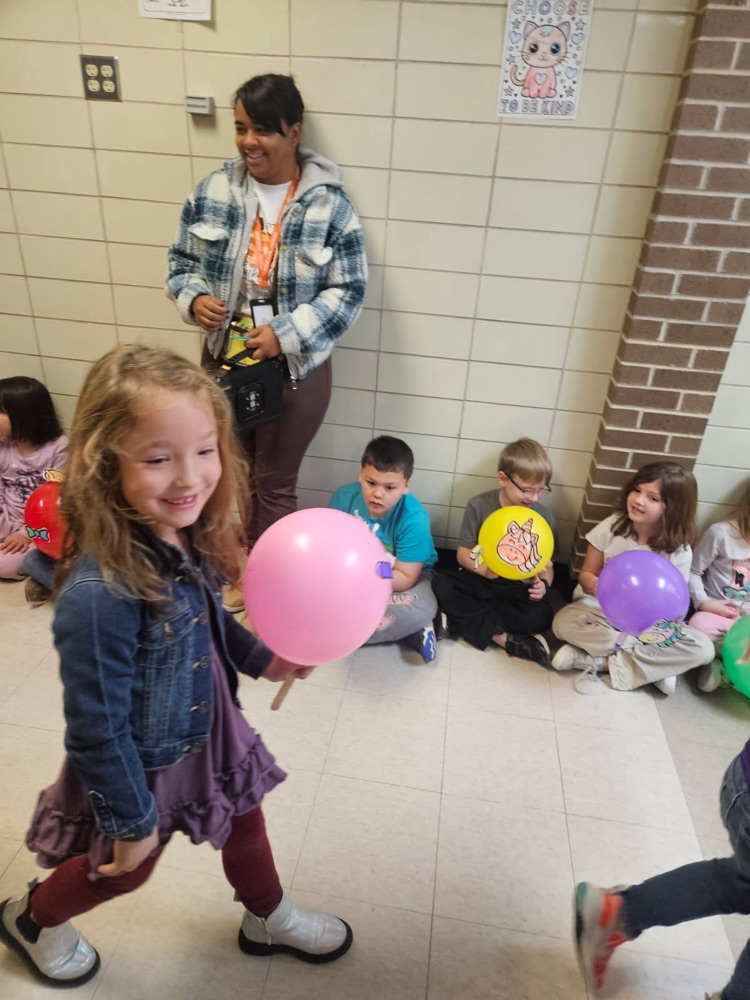 Students parading with balloons.