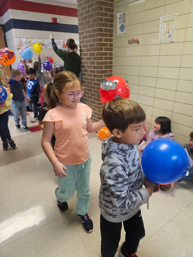 Students parading with balloons.