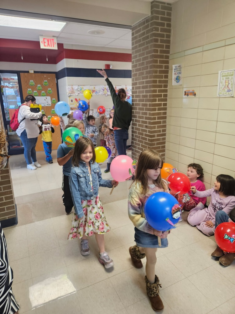Students parading with balloons.