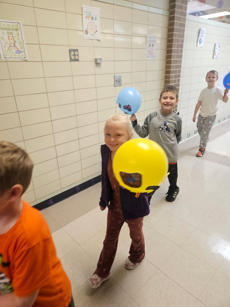 Students parading with balloons.