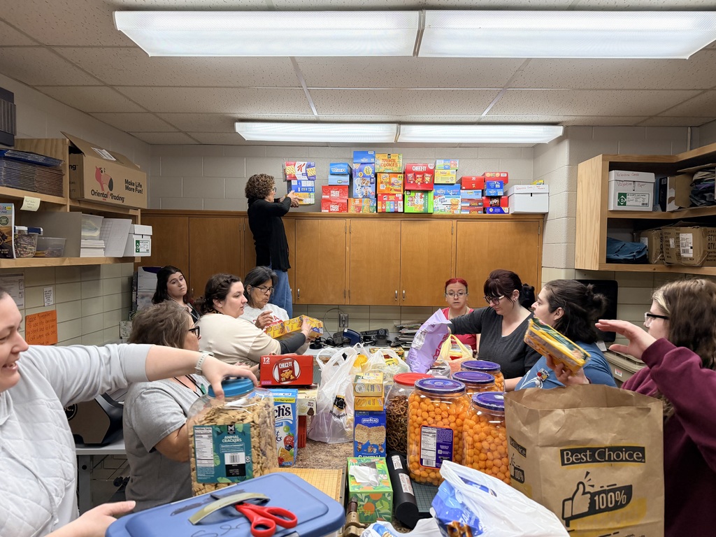 Staff working together to stock donated snacks.
