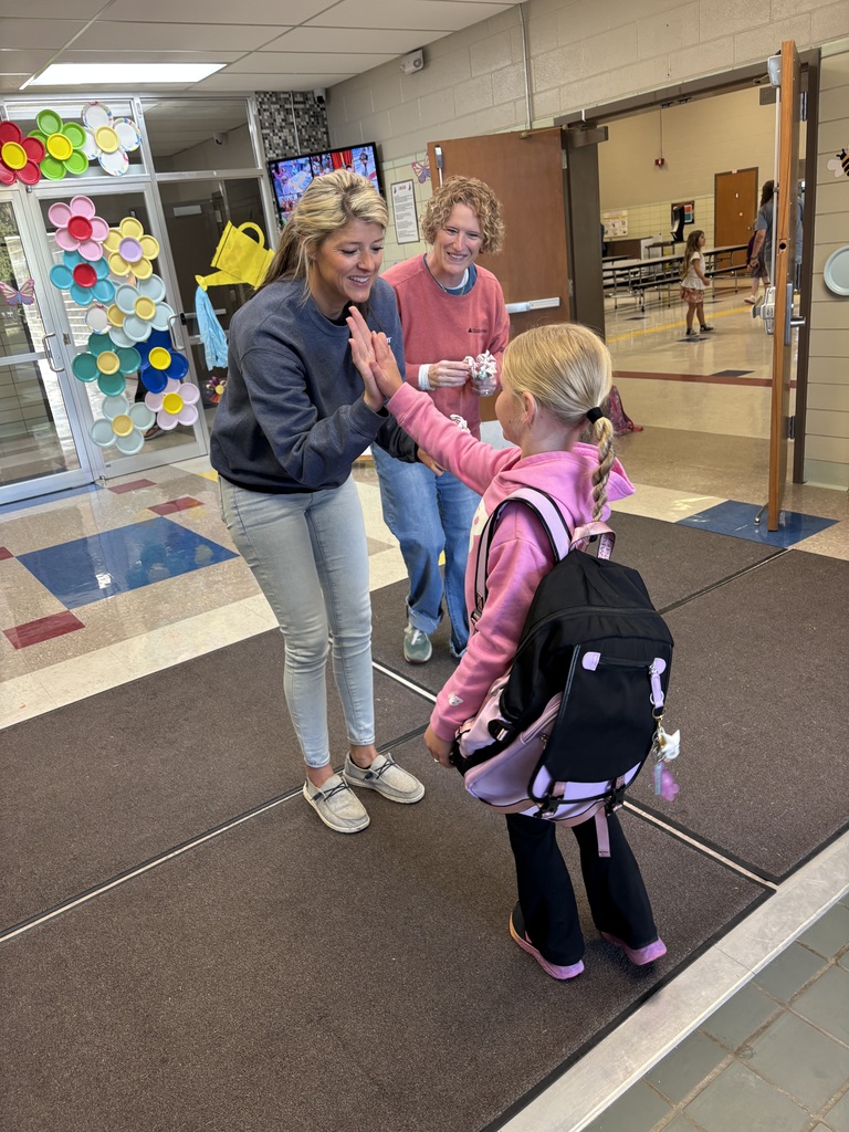 Amanda West high fiving students.