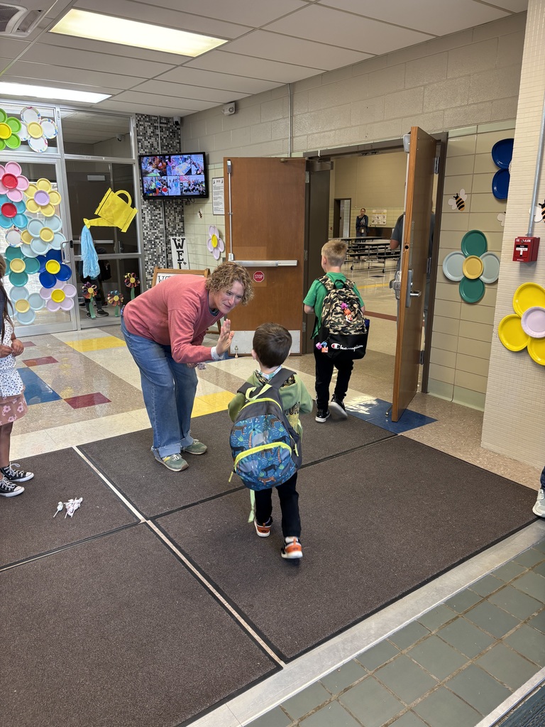 Katie A. high fiving kids.
