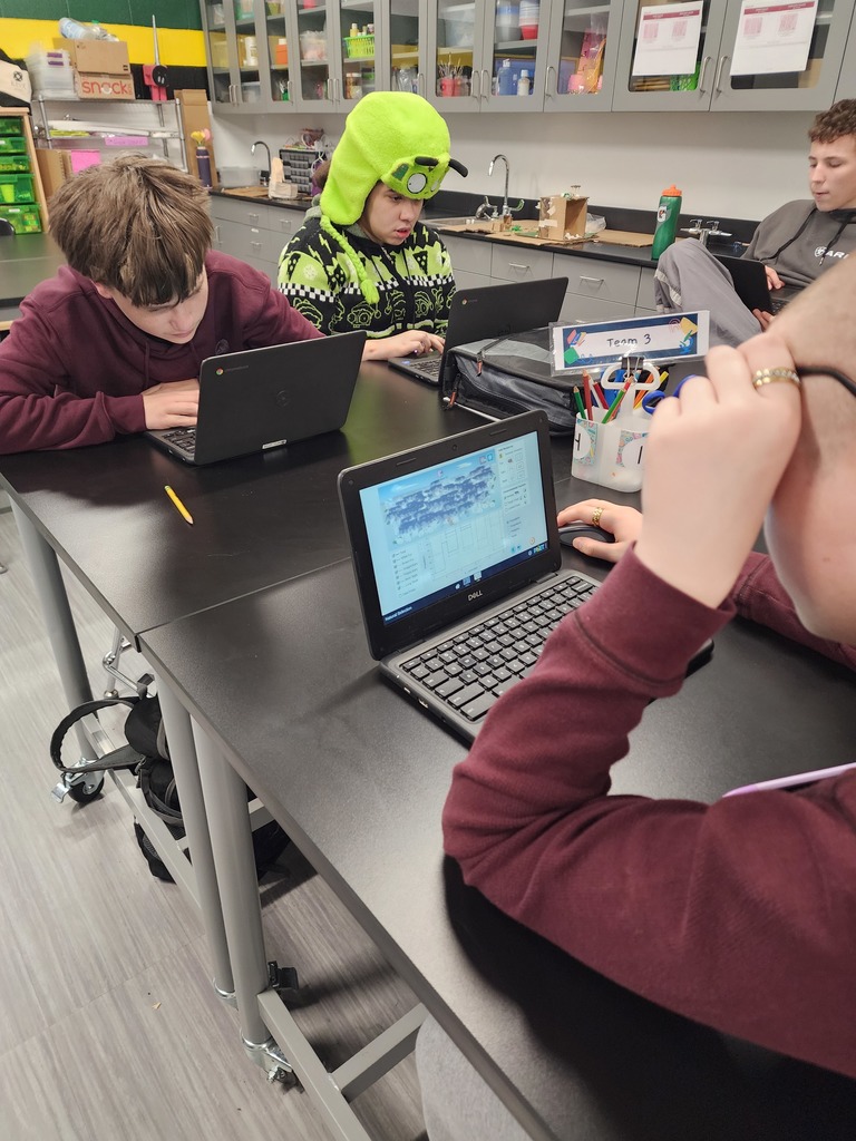 8th-grade science students using interactive simulations to learn about natural selection.