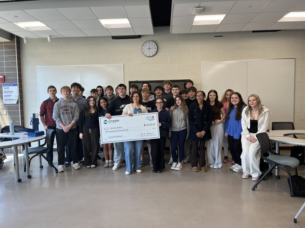Ms. Roher surprised during class with her grand prize giant check