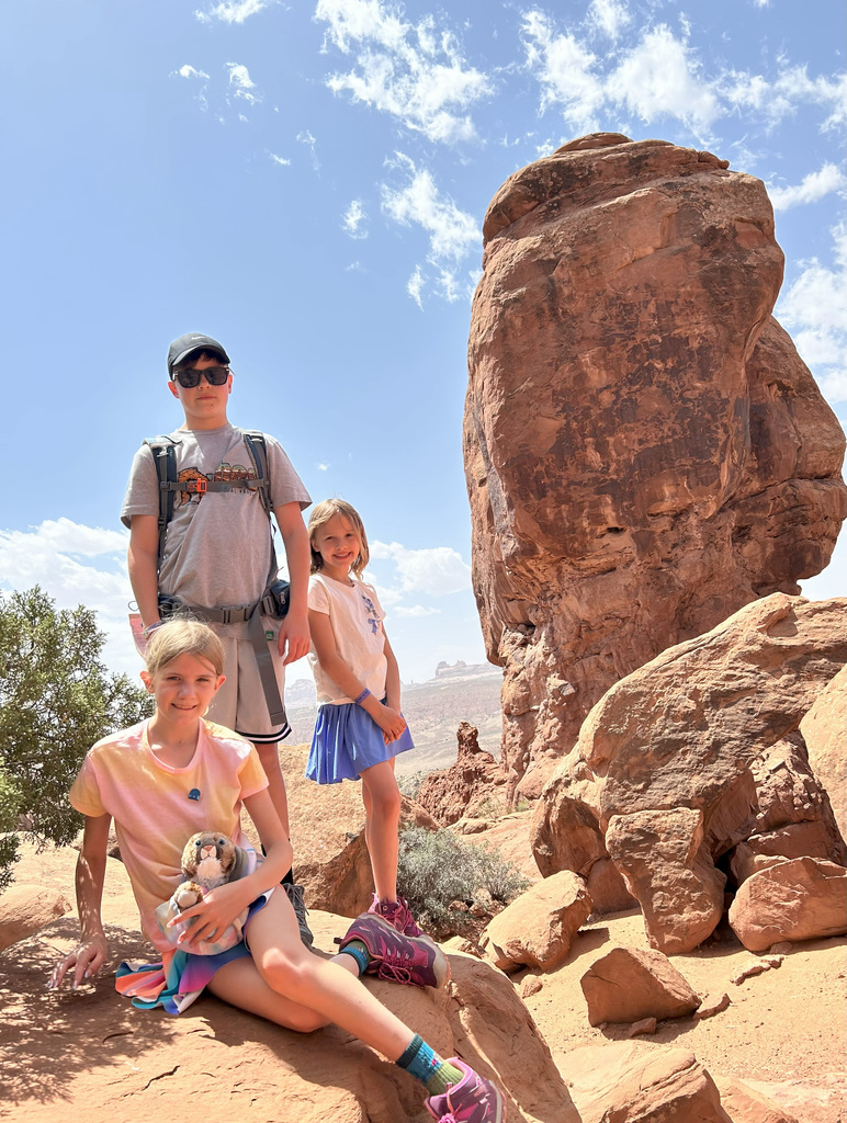 Michelle, Melanie and Isaak pose on the rocks while on a family RV trip to the national parks in Colorado and Utah