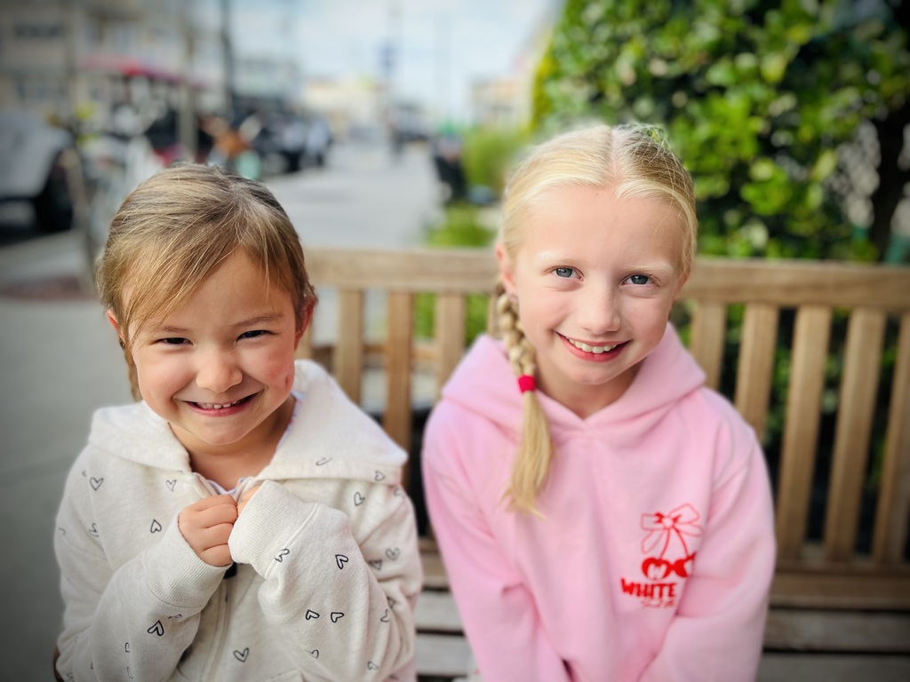 Cousins Jasmine Leia sitting on a bench together while vacationing in Sea Isle City, New Jersey
