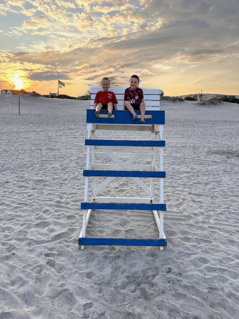 2 upcoming kindergarteners sit in a lifeguard post at sunset on the beach in Wildwood