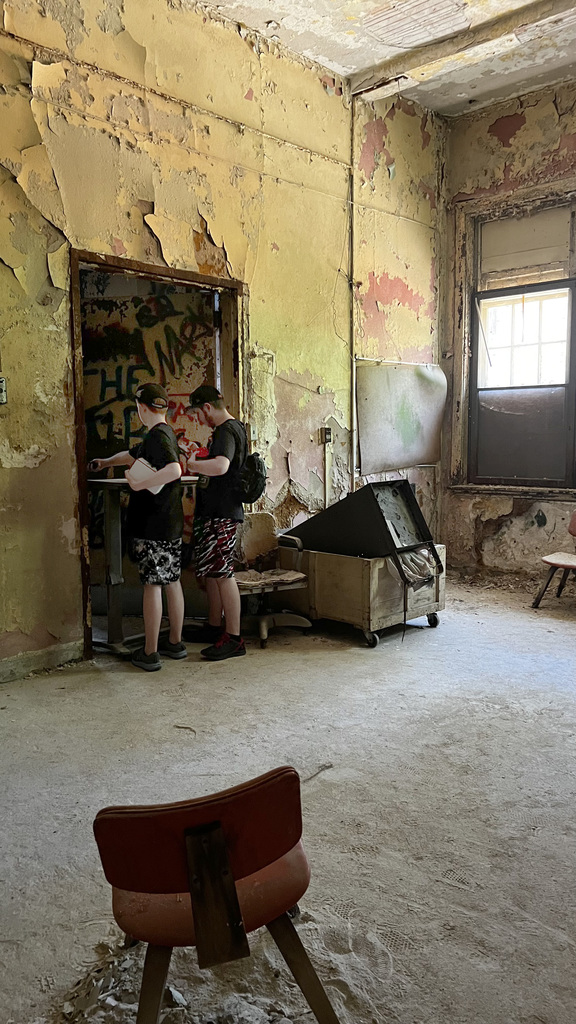 Ryan and Nicholas explore a room while on their ghost hunt, looking for paranormal evidence