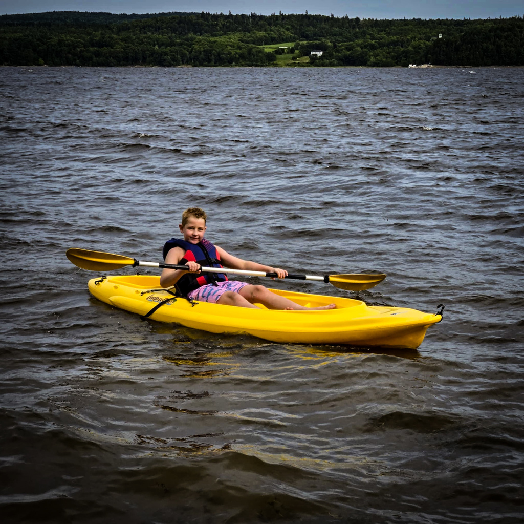 Henry rows a kayak on the St. John River in Canada