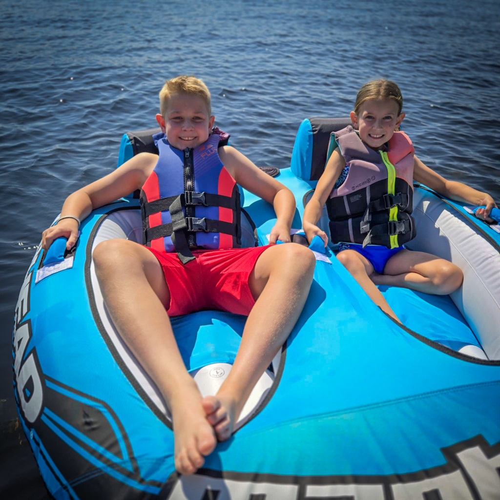 Henry and Alexis riding in a tube on the St. John River in Canada