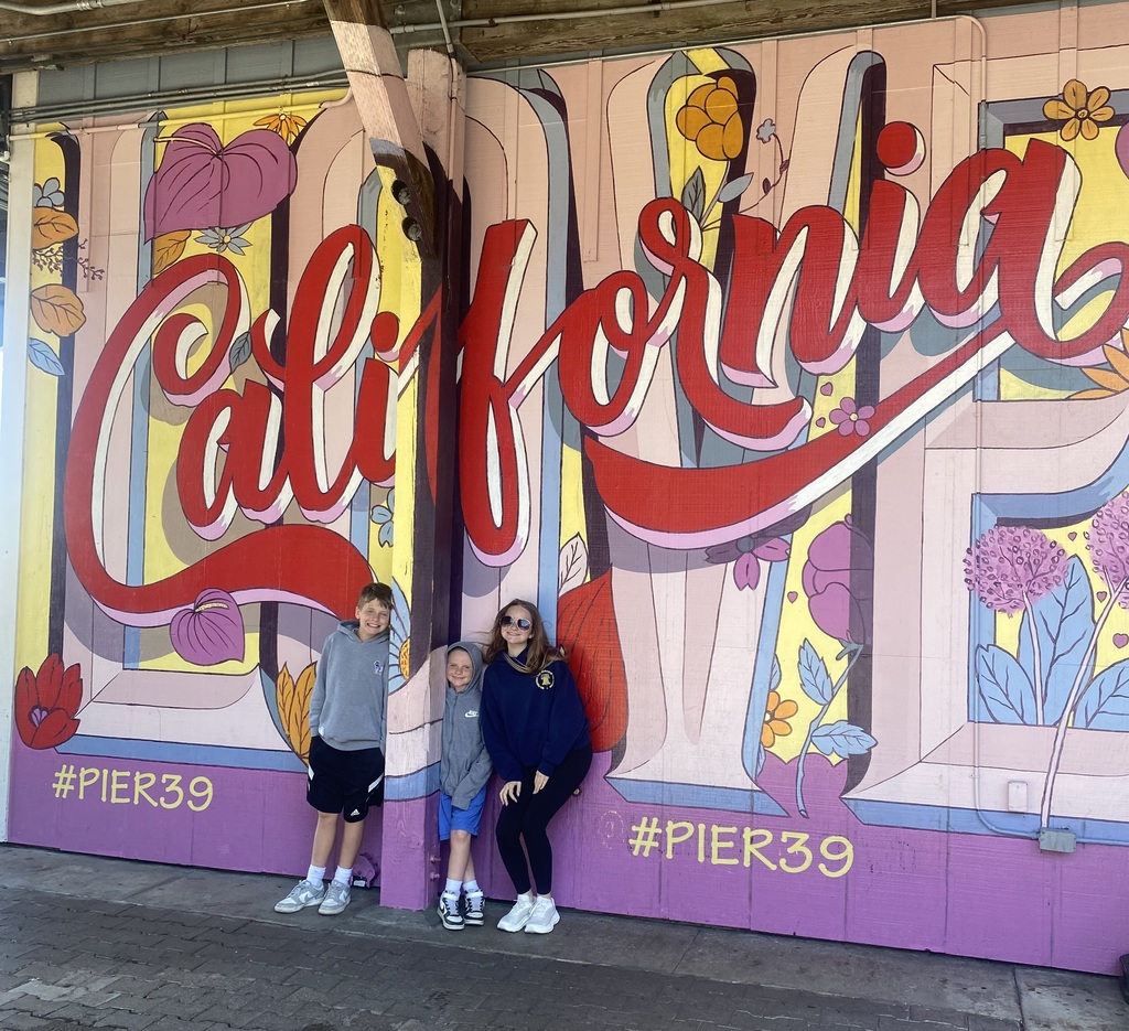 Claire, Declan and Ryan Sullivan standing before a mural in California, where they traveled for a week this summer