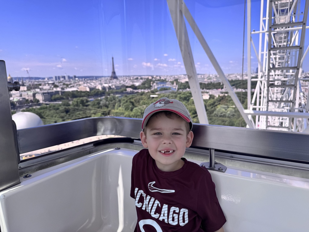 Leo enjoys an amusement ride while exploring Paris, France