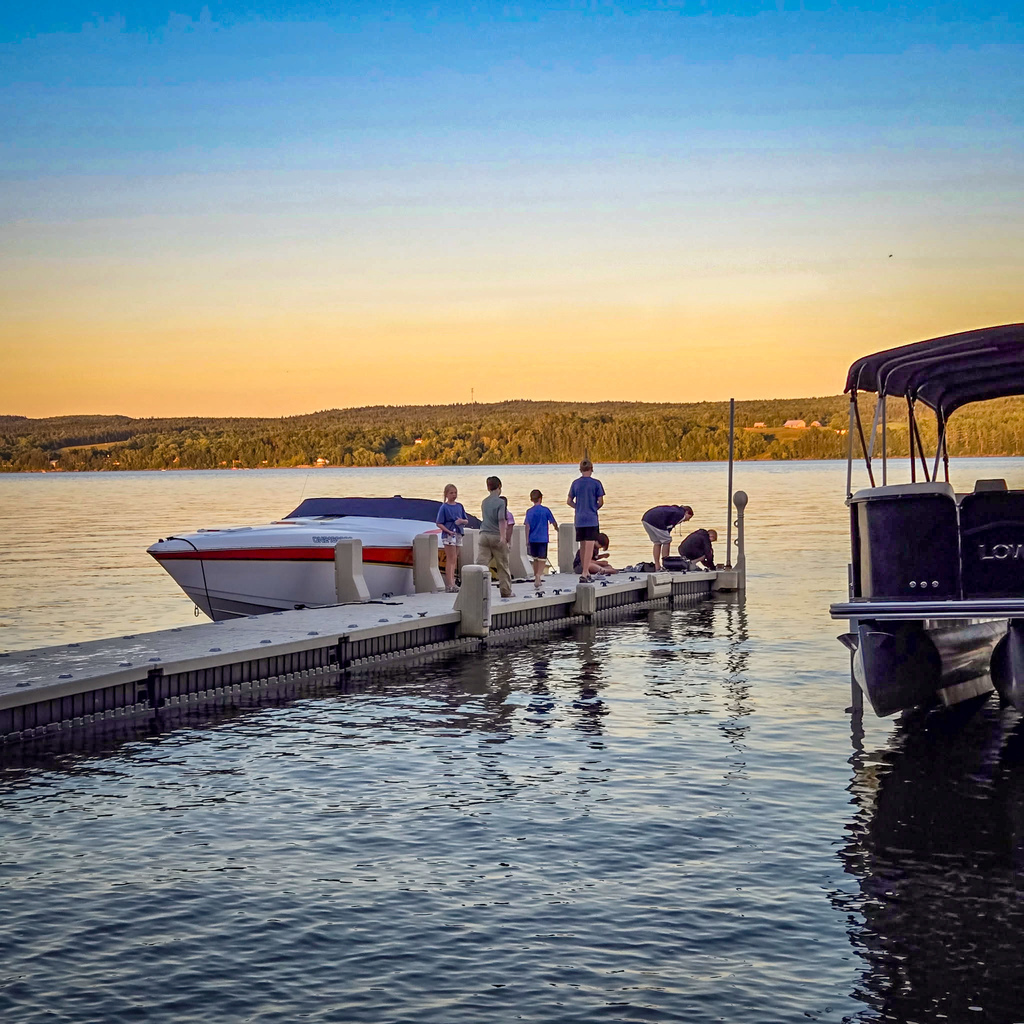 Henry, Alexis and their famility on a pier on the St. John River in Canada