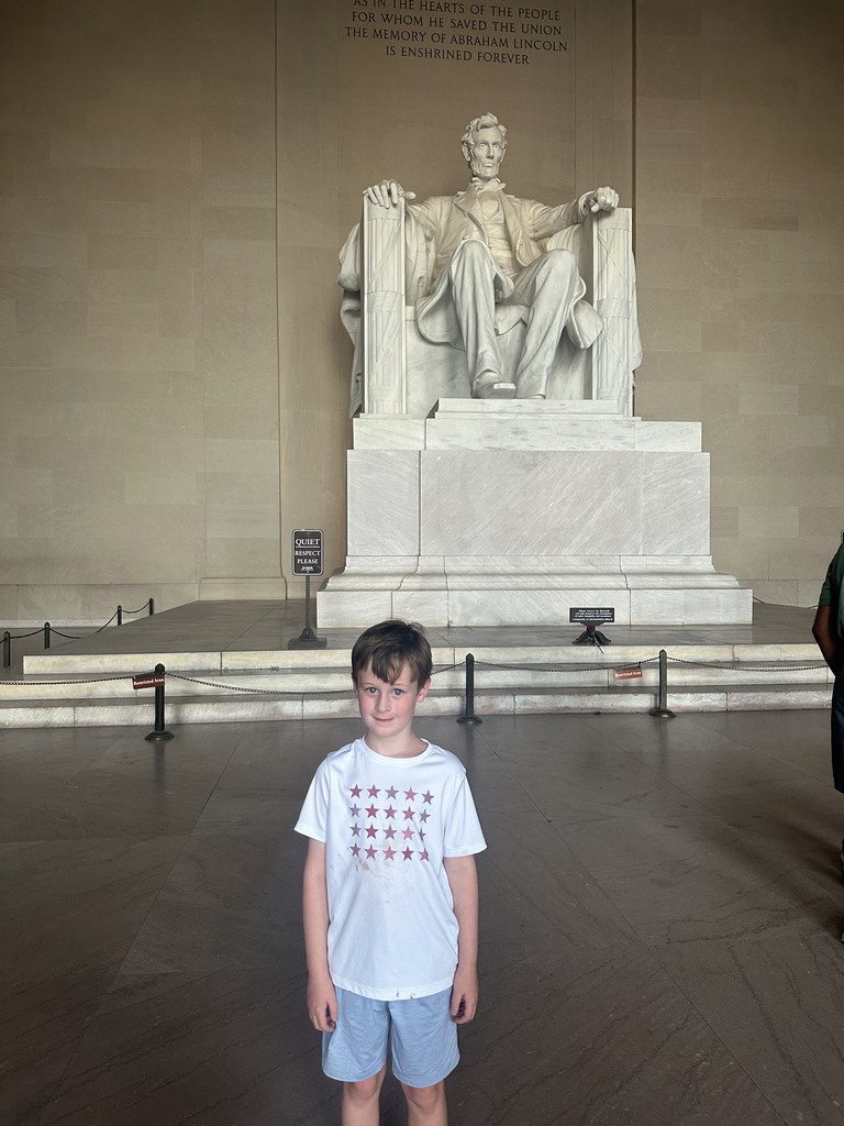 Robbie  stands in front of the Lincoln Memorial statue