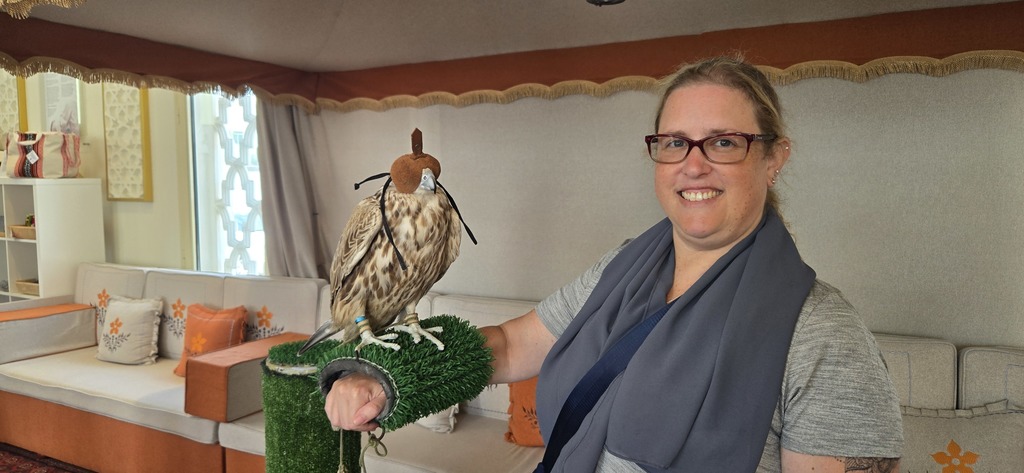 Ms. Goldberg holds a falcon on her arm