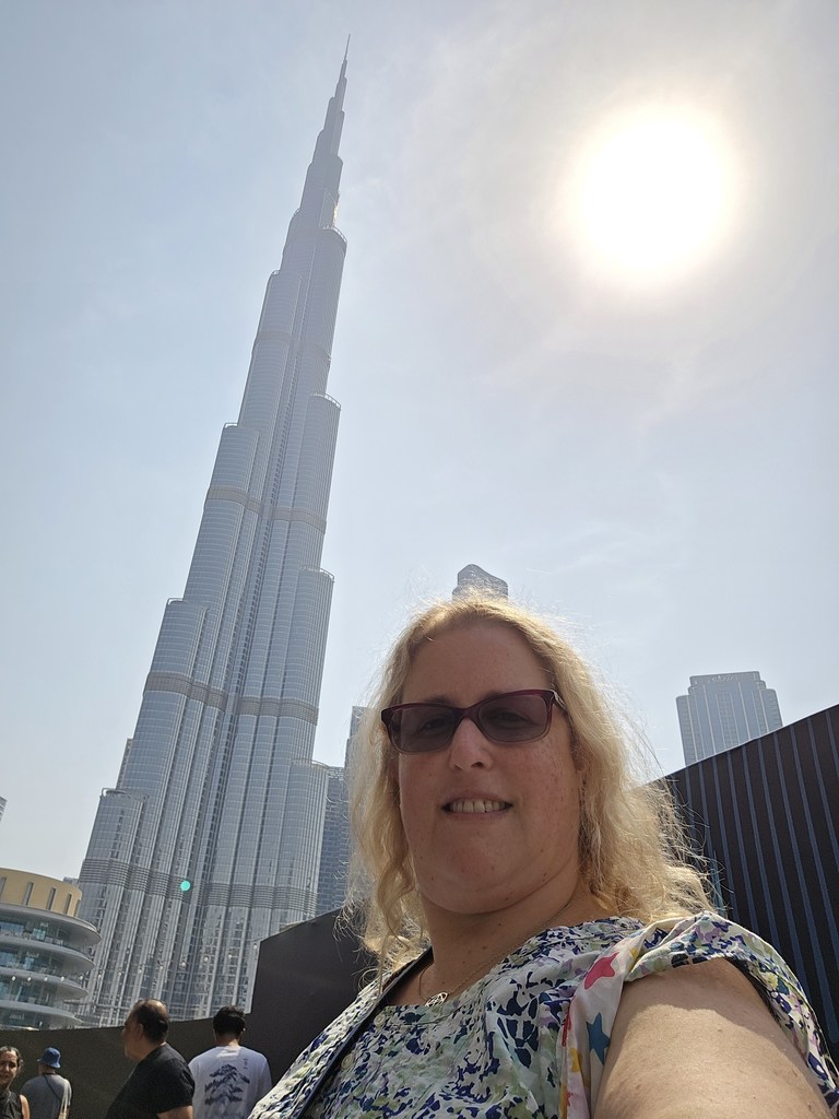 Ms. Goldberg stands outside with the Burj Khalifa skyscraper in the background