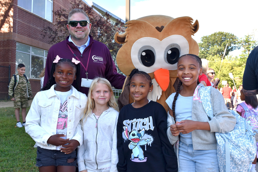 Dr.  Fecher and the Overlook Owl welcome students on the first day of school