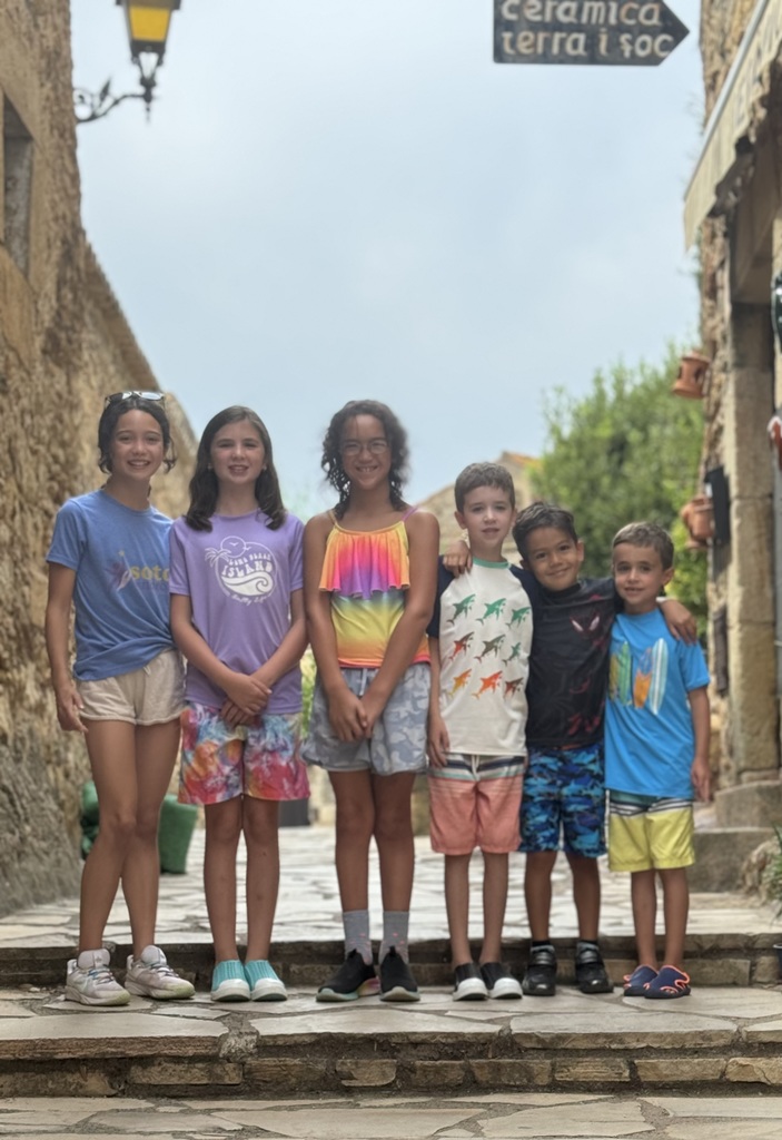 5 Abington students pose on ancient stone steps in Spain